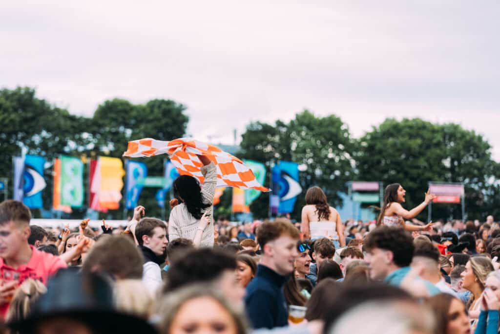 An Orange and White flag being waved in the crowd
